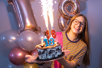 Blonde girl smiling with a cake