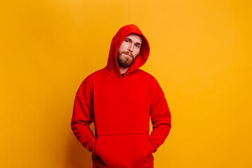 Happy  caucasian handsome brutal bearder man wearing warm red winter trendy fleece hoodie, studio...