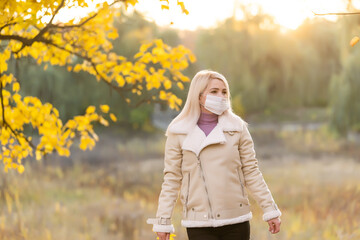 Woman wearing a face mask in a park during quarantine