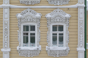 Ornamental carved windows, decorative frames on vintage wooden house on Pushkin Street, 38, Tomsk...