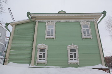 Vintage wooden house with ornamental carved windows, frames in Pushkin Street, 38, Tomsk city,...
