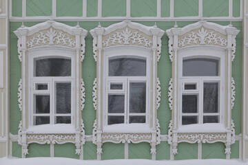 Ornamental carved windows, decorative frames on vintage wooden house on Pushkin Street, 40, Tomsk...