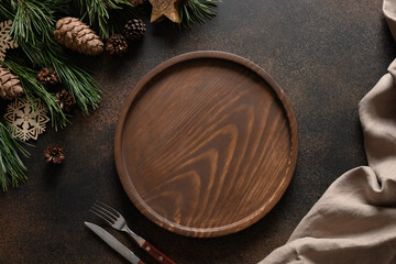Christmas composition of wooden tray for holiday homemade dish on brown cozy home table with natural decoration. Top view.