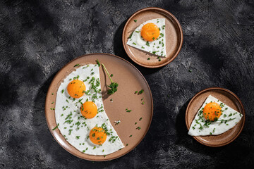 Fried eggs on a ceramic plate with herbs