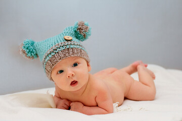Portrait of a cute 2 months baby lying down on a blanket.