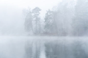 Obraz na płótnie Canvas Foggy November morning view of the lake and forest in Vilnius Lithuania