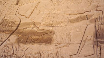 Karnak temple large scale wall craved Pharaoh and row of people