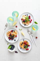 Pancakes with fresh blueberry and raspberry served for healthy vegetarian breakfast