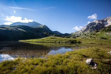 Mountain lake. Mountain peaks are reflected in the water