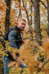 Guy tourist walks in a foggy autumn forest