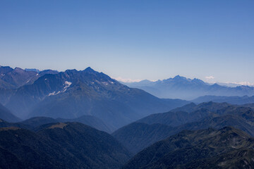 Fototapeta na wymiar View of endless mountain ranges in the haze of the day
