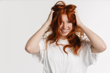 Ginger beautiful happy girl smiling and making fun with her hair