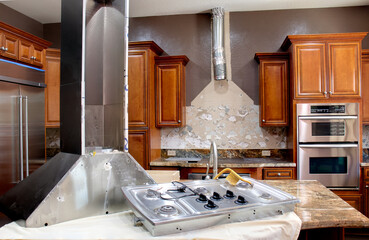 Home remodeling kitchen renovation with appliances removed and damaged walls