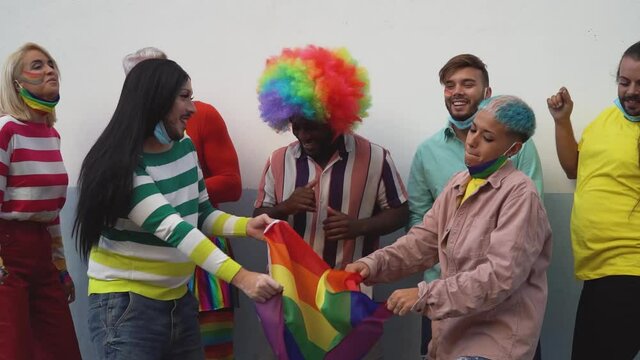 Happy Multiracial people having fun dancing and celebrating gay pride festival event - Lgbt concept  