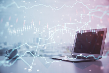 Forex graph hologram on table with computer background. Multi exposure. Concept of financial...