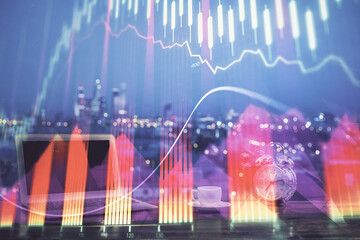 Obraz premium Stock market chart hologram drawn on personal computer background. Multi exposure. Concept of investment.