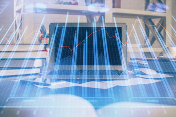 Double exposure of graph and financial info and work space with computer background. Concept of international online trading.