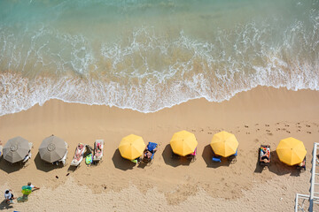 Tourists vacationing on Waikiki Beach on Oahu, Hawaii. 