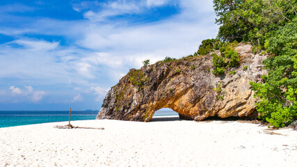 The rock arch at Koh Khai Island on the way to Lipe Island , Satun, Thailand.