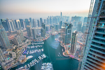 DUBAI, UAE - DECEMBER 6, 2016: Aerial view of Dubai Marina at sunset. Skyscrapers along the canals