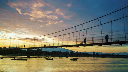 Wooden bridge across the River in the evening.