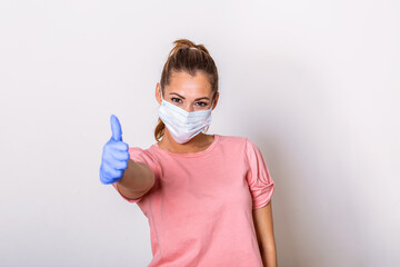 Woman with protective mask showing thumb up, and looking at camera. Woman with face mask protection of Coronavirus in human lungs. MERS-CoV, SARS, Adenoviruses and other respiratory viruses