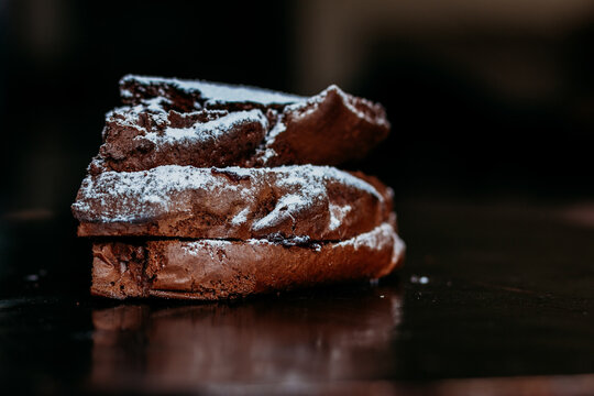 chocolate cake with sugar pouder in the dark background