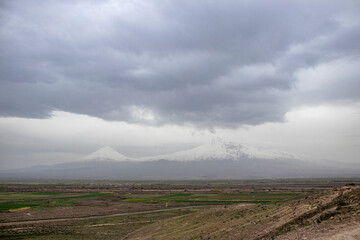 Armenia. Landscape of Mount Ararat. Snow-capped mountain peaks. Cumulus clouds.