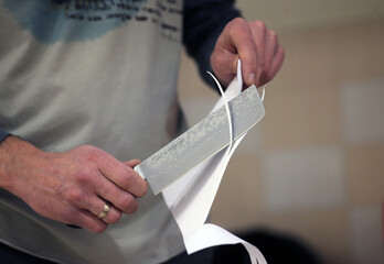 Knife sharpener and hand with blade
