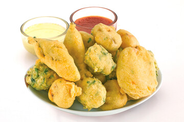 Indian Street Fried Food Pakora Also Know as Pakoda, Bhajiya, Bhajia, Methi Gota, Kanda Bhaji, Pyaz Pakoda, Fried Chillies, Onion Wada, potato vada, aloo Bhajji or fritter, Served with Chutney.