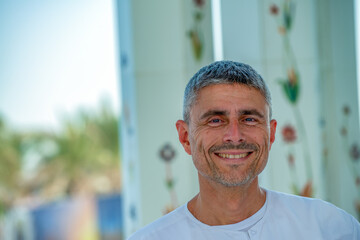 Happy caucasian tourist visiting Sheikh Zayed Mosque in Abu Dhabi, UAE