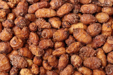 Top view of raw tiger nuts or chufa as background, close up.