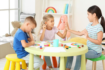 Obraz na płótnie Canvas Little children painting rainbow during Covid-19 quarantine at home