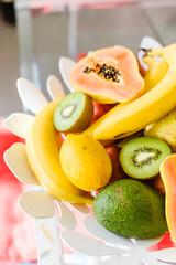 Fototapeta na wymiar Plate of mixed exotic fruit on the kitchen table