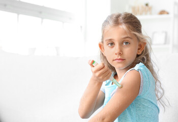 Little diabetic girl giving herself insulin injection at home
