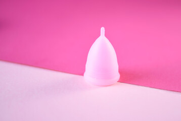 Menstrual cup on a color background. The concept of critical days.