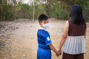 .Mother and son wear a mask to protect the virus. Covid-19