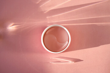 Pink hydrogel eye patches оn a pink background. Bathroom treatments. Homemade face care.