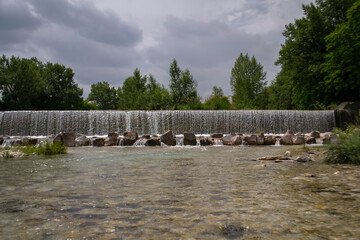 waterfall flows among stones in the forest