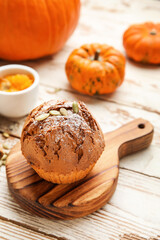Tasty pumpkin muffin on table