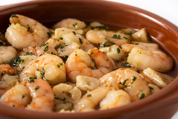Garlic prawns in crock pot isolated on white background. 	 Close up