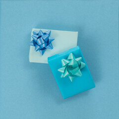 Two gift boxes wrapped in light blue paper, with ribbon. Isolate.