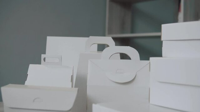 Different design and shape of cardboard boxes, paper containers. The concept of production and development of packaging. Industry