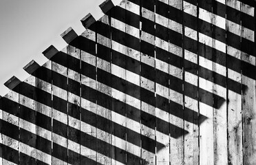 Light and shadow concept, The sunlight shines through the wooden awning on the wall, Abstract background.