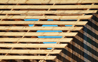Light and shadow concept, The sunlight shines through the wooden awning on the wall, Abstract background.