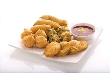 Indian Street Fried Food Pakora Also Know as Pakoda, Bhajiya, Bhajia, Methi Gota, Kanda Bhaji, Pyaz Pakoda, Fried Chillies, Onion Wada, potato vada, aloo Bhaji or fritter, Served with Chutney.