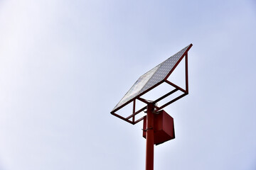 Fototapeta na wymiar Solar battery on a pole against a blue sky