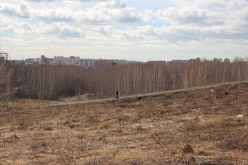 Hills in the Park in the fall a man goes to the city on the road