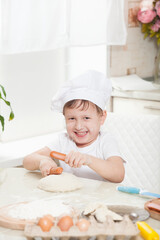 baby knead the dough in flour