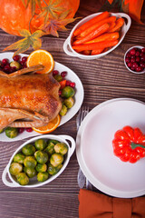 Table served for thanksgiving dinner. Stuffed roasted turkey. Traditional celebrating holiday.
